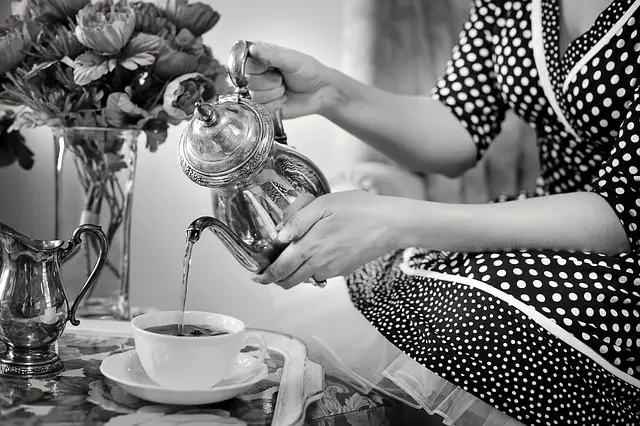 lady in polka dress pouring tea