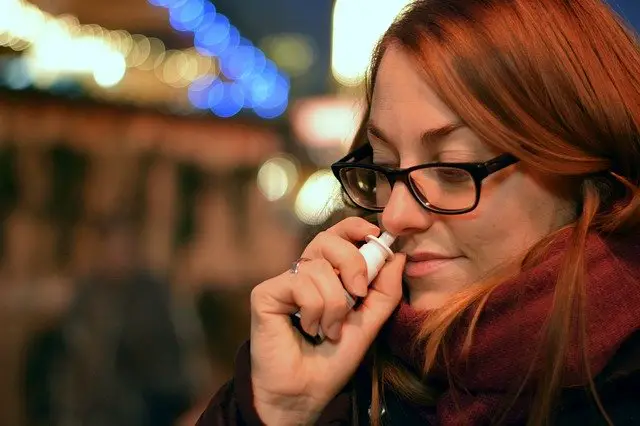 lady using nasal spray