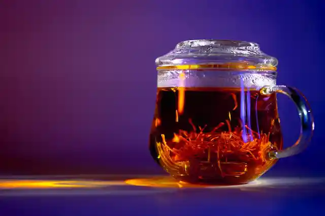 saffron tea in glass kettle